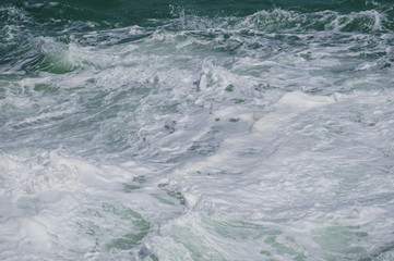 Fototapeta na wymiar Stormy waves near a rocky shore