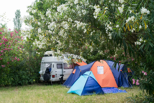 Campsite with caravan and tent in summertime.