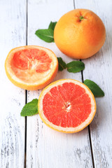 Ripe grapefruits on color wooden background