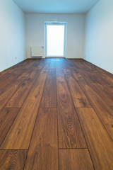 Empty apartment interior with wooden floor after renovation