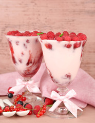 Tasty raspberry dessert with berries on pink wooden background