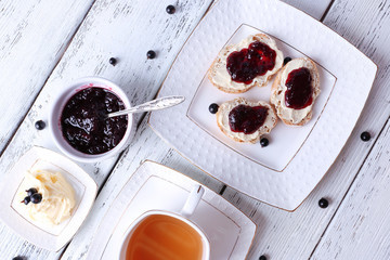 Fresh toasts with homemade butter and blackcurrant jam