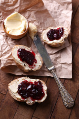 Fresh bread with homemade butter and blackcurrant jam