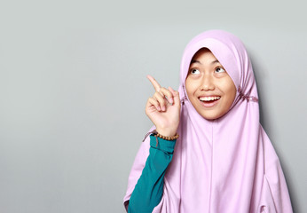 muslim young girl pointing up
