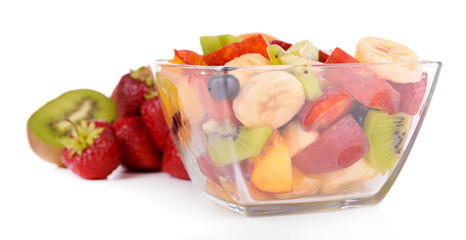 Fresh fruits salad in bowl with fruits and berries isolated