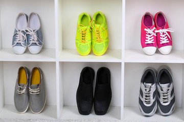 Colorful shoes on wooden shelves