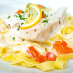 plate of pasta and smoked salmon with tomato