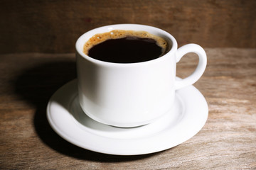 Obraz na płótnie Canvas Cup of coffee on wooden background