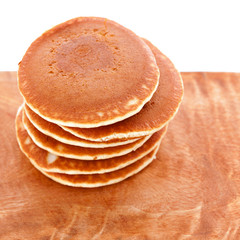Stack of pancakes on wooden board with white background