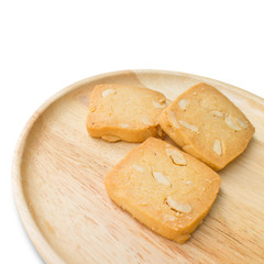 3 cashew nut cookies on a wooden plate and white background