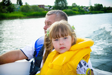 Fototapeta na wymiar Water travel in the family boat in the summer