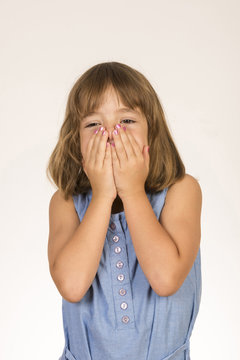 Little girl covering her face with hands