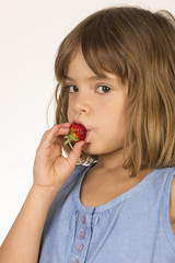 Little Girl Eating Strawberry