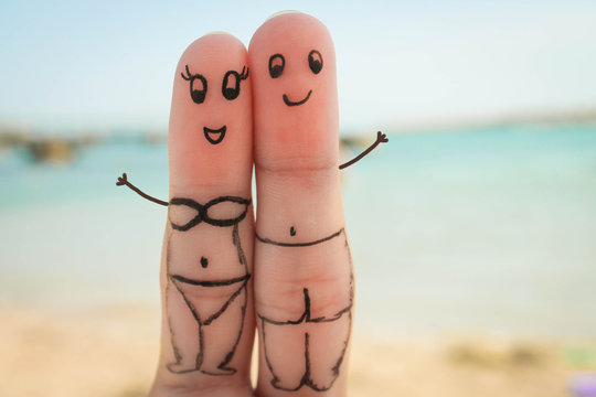 Happy Couple  Have A Rest On The Beach In Bathing Suits.