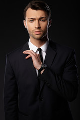 Portrait of young business man. Black background