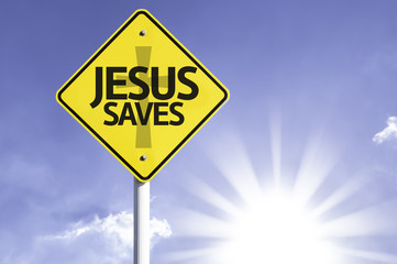 Naklejka premium Jesus Saves road sign with sun background