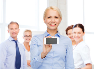 smiling businesswoman with smartphone blank screen