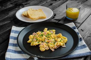Scrambled eggs on frying pan