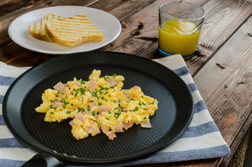 Scrambled eggs on frying pan