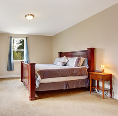 Soft ivory bedroom with big burgundy bed