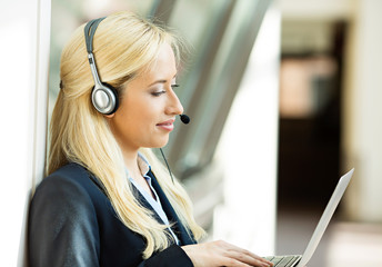 Female customer service representative using hands free device