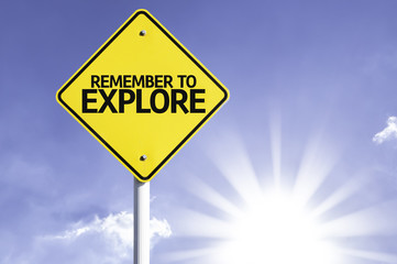 Remember to Explore road sign with sun background