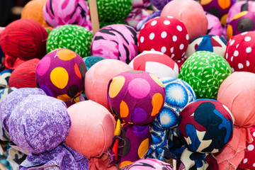 A pile of colorful fabric balls