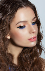 Visage. Pensive Woman with Blue Mascara and Holiday Makeup
