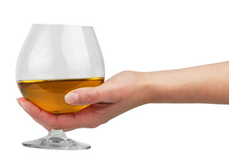 Glass goblet with brandy in hand