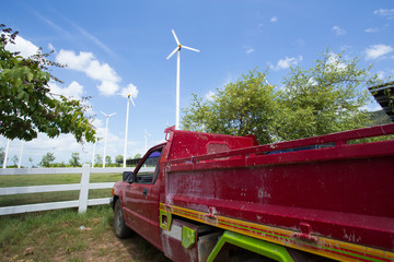 wind turbines, field of wind turbines with red truck © akeeris
