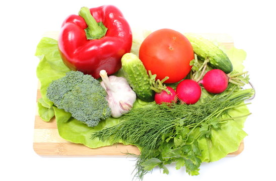 Fresh ripe raw vegetables on wooden cutting board