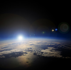 Fototapeta na wymiar Sunrise over the Earth from space.