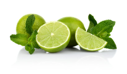 Three sliced limes with mint isolated on a white background