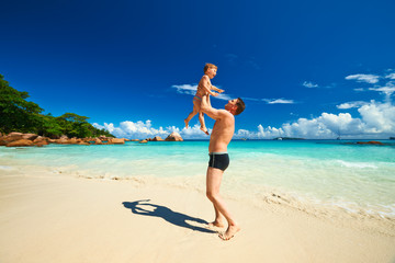 Father and two year old boy playing on beach