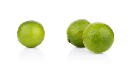 Three whole limes isolated on a white background