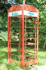 Old red telephone box in the park.