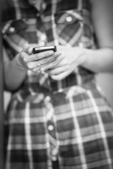 Woman using mobile smart phone in the park.