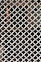 The overlapping white wooden lattice.