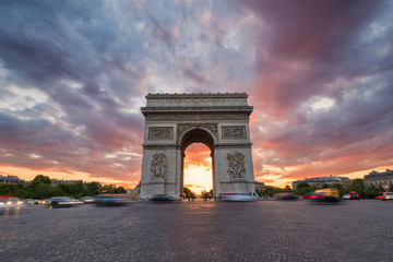 Fototapeta na wymiar Arc de Triomphe and traffic along the Champs-Elysees at sunset w