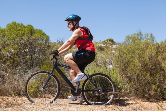 Fit man cycling on mountain trail