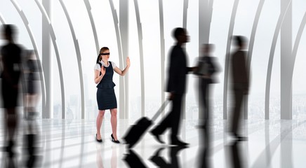 Composite image of redhead businesswoman in a blindfold