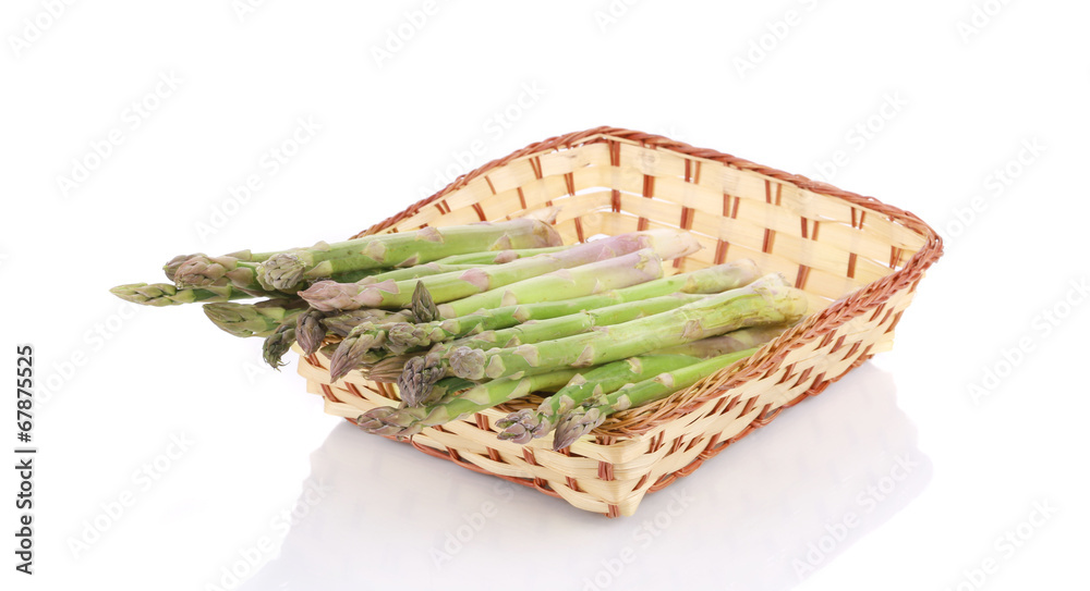 Poster Wicker basket full with asparagus.