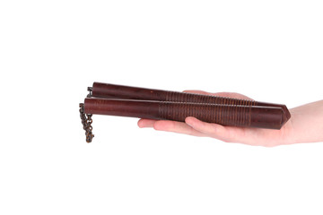Hands hold martial arts nunchaku.