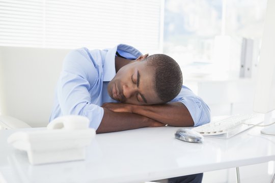 Tired Businessman Sleeping At His Desk