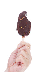 Hand holds chocolate ice cream.