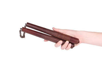 Hand holding nunchaku weapon.