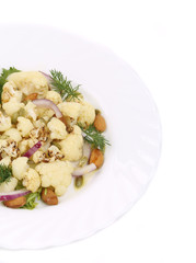 Cauliflower salad with nuts and red onion.