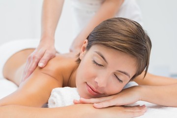 Fototapeta premium Attractive woman receiving back massage at spa center