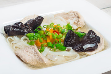 Homemade chicken soup with rice noodles