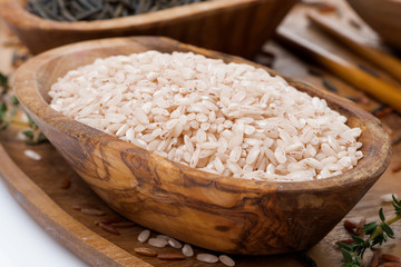 pink unpolished rice in a wooden bowl, close-up